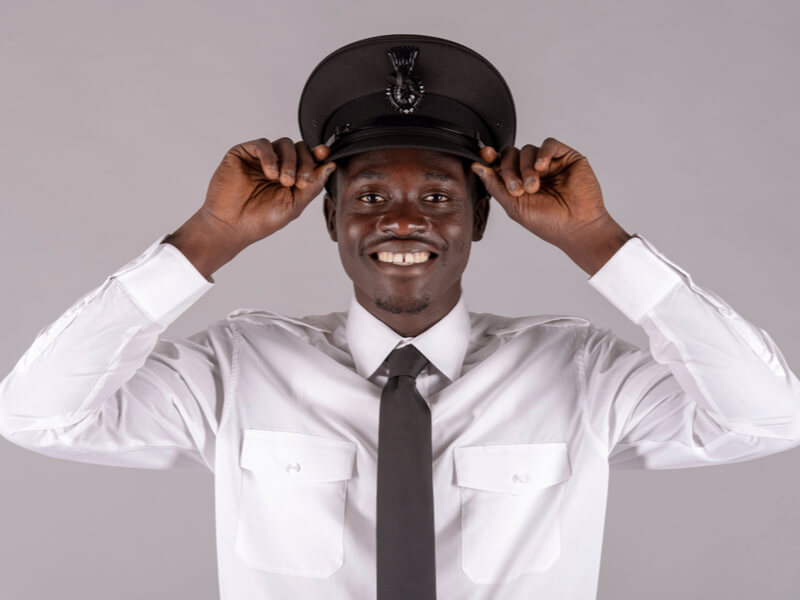 A pilot holding his black hat